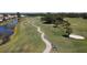 Scenic golf course featuring winding cart paths, lush greenery, and mature trees offering a serene golfing experience at 1853 San Silvestro Dr, Venice, FL 34285
