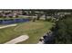 Beautiful golf course with players, a serene pond, manicured greens, and mature trees enhancing the golfing experience at 1853 San Silvestro Dr, Venice, FL 34285