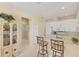 Eat-in kitchen boasts white cabinets, stainless appliances, and breakfast bar with seating at 1853 San Silvestro Dr, Venice, FL 34285