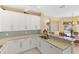 Open kitchen design with eat-in counter, light tile backsplash, and stainless appliances at 1853 San Silvestro Dr, Venice, FL 34285