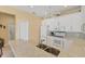 Bright kitchen features white cabinetry, stainless appliances, and eat-in bar at 1853 San Silvestro Dr, Venice, FL 34285