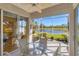 Enclosed lanai with ceiling fan overlooking a tranquil lake view at 1853 San Silvestro Dr, Venice, FL 34285