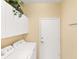 A simple laundry room setup featuring a washer and dryer and storage space at 1853 San Silvestro Dr, Venice, FL 34285