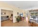 Bright and airy living room featuring wood floors, neutral paint, lots of space, and sliding glass doors to the lanai at 1853 San Silvestro Dr, Venice, FL 34285