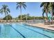 Resort-style outdoor pool featuring lap lanes, lounge seating and umbrellas creating the perfect place for relaxation at 1853 San Silvestro Dr, Venice, FL 34285