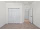 Empty bedroom with neutral carpet and double closets at 1888 Batello Dr, Venice, FL 34292