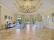 Inviting lobby area with comfortable seating and elegant chandelier at 1888 Batello Dr, Venice, FL 34292