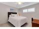 Bedroom with a queen bed, white bedding, tiled floor, ceiling fan, and window at 200 Park N Blvd # 108, Venice, FL 34285