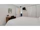 Bedroom featuring a desk, closet, and queen bed with white bedding at 200 Park N Blvd # 108, Venice, FL 34285