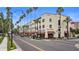 Historic KMI Building with stores and restaurants along a street lined with palm trees at 200 Park N Blvd # 108, Venice, FL 34285
