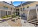 Charming courtyard with stone benches and lush landscaping, providing a tranquil outdoor space at 200 Park N Blvd # 108, Venice, FL 34285