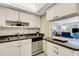 Bright kitchen featuring white cabinets and modern appliances, offering a clean and functional space at 200 Park N Blvd # 108, Venice, FL 34285