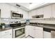 Modern kitchen features stainless steel appliances and white cabinets, providing a clean cooking space at 200 Park N Blvd # 108, Venice, FL 34285