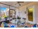 Screened lanai with a round glass table, four white chairs, and a ceiling fan at 200 Park N Blvd # 108, Venice, FL 34285