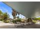 Inviting outdoor seating area with stone benches and tables, perfect for relaxing and enjoying the tropical surroundings at 200 Park N Blvd # 108, Venice, FL 34285