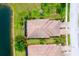 Overhead shot of house and property, highlighting the roof, garden, and lake at 20176 Tesoro Dr, Venice, FL 34293