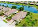 An aerial shot highlights the property's landscaping and scenic lake views at 20176 Tesoro Dr, Venice, FL 34293