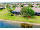 An aerial shot displays the home with its backyard, landscaping and screen enclosed patio at 20176 Tesoro Dr, Venice, FL 34293