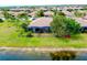 An aerial shot displays the home with its backyard, landscaping and screen enclosed patio at 20176 Tesoro Dr, Venice, FL 34293
