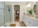 Elegant bathroom with double vanity, glass shower, and stylish decor at 20176 Tesoro Dr, Venice, FL 34293