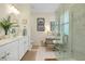 Modern bathroom with double sinks, a vanity area, and glass-enclosed shower at 20176 Tesoro Dr, Venice, FL 34293