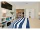 Bedroom featuring stylish bed with blue striped bedding and open doorway to dining area at 20176 Tesoro Dr, Venice, FL 34293