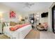 Sunlit bedroom with a work desk, flamingo artwork, and access to a patio at 20176 Tesoro Dr, Venice, FL 34293