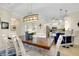 The dining room is bright and open, featuring a wooden table, white chairs and kitchen view at 20176 Tesoro Dr, Venice, FL 34293