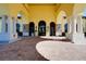 Impressive building entrance with arched openings, stone accents, and manicured landscaping at 20176 Tesoro Dr, Venice, FL 34293