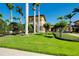 Beautiful building surrounded by lush tropical landscaping with palm trees on a sunny day at 20176 Tesoro Dr, Venice, FL 34293