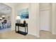 Inviting foyer featuring a console table, artwork, and an arched entryway to adjacent spaces at 20176 Tesoro Dr, Venice, FL 34293