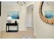 Elegant foyer with tile flooring, decorative mirror, and stylish console table with lamp at 20176 Tesoro Dr, Venice, FL 34293