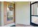 Inviting front door with a glass panel and a decorative wreath, next to a screened entry at 20176 Tesoro Dr, Venice, FL 34293