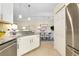 Bright kitchen features stainless steel appliances, granite countertops, and a dining area at 20176 Tesoro Dr, Venice, FL 34293