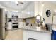The gourmet kitchen features granite counters, stainless steel appliances, and tile backsplash at 20176 Tesoro Dr, Venice, FL 34293