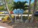 Centennial Park welcome sign surrounded by lush tropical plants, inviting visitors to enjoy at 20176 Tesoro Dr, Venice, FL 34293