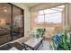 Inviting screened patio features comfortable seating, stylish decor, and views of the lake at 20176 Tesoro Dr, Venice, FL 34293