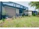 View of an enclosed patio with outdoor furniture and view of the green backyard at 20176 Tesoro Dr, Venice, FL 34293