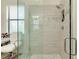 The bright tiled shower features elegant glass enclosure and decorative accent tile at 20176 Tesoro Dr, Venice, FL 34293