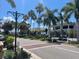 Bustling street view with tropical trees, commercial buildings, and shops lining the road at 20176 Tesoro Dr, Venice, FL 34293