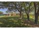 Community clubhouse is surrounded by lush trees and landscaping, offering a picturesque setting at 206 Silver Lake Dr # 105, Venice, FL 34292