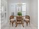 Cozy dining nook next to bright bay windows with white shutters, under a hanging light fixture at 206 Silver Lake Dr # 105, Venice, FL 34292