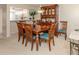 Elegant dining room features a wood table and hutch, creating a warm, inviting space for meals at 206 Silver Lake Dr # 105, Venice, FL 34292