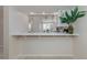 Kitchen and breakfast bar area offering a casual dining option and serving as a transition between the kitchen and living room at 206 Silver Lake Dr # 105, Venice, FL 34292