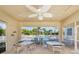 Charming covered patio area with ample seating, offering a delightful space for outdoor dining and overlooking the pool at 206 Silver Lake Dr # 105, Venice, FL 34292