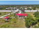 Expansive property featuring lush landscaping and a charming red-roofed home near the coast with a detached building at 2211 Englewood Rd, Englewood, FL 34223