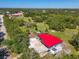 Overhead shot of the property showing the main house and outbuildings set within lush green surroundings at 2211 Englewood Rd, Englewood, FL 34223