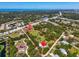 Aerial view showcasing the property's layout, surroundings, and proximity to the coastline and nearby amenities at 2211 Englewood Rd, Englewood, FL 34223