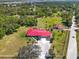 Stunning aerial view of the property featuring a house, a detached building, and expansive green space at 2211 Englewood Rd, Englewood, FL 34223