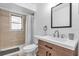 Updated bathroom featuring a modern vanity, stylish fixtures, and a shower with tiled surround at 2211 Englewood Rd, Englewood, FL 34223